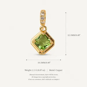 Macro view of square green zircon pendant in gold copper finish with stone accents