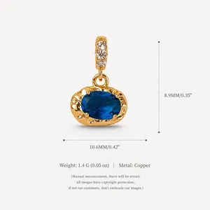 Detailed macro view of oval blue zircon pendant in gold-plated copper with dimensions