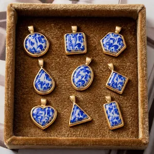 Collection of blue and white porcelain style resin pendants in gold stainless steel frames