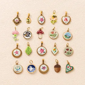 Detailed view of 18K gold-plated stainless steel pendants with vintage floral designs
