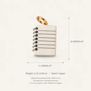Close-up detail of a copper notebook pendant showing precise dimensions and material specs