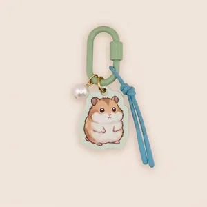 Close-up detail of cute acrylic hamster keychain with green carabiner and blue rope