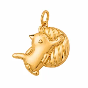 Close-up of a 316L stainless steel gold cat pendant playing with a textured ball.