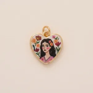 Detailed view of a gold-rimmed heart pendant featuring a romantic floral woman illustration.