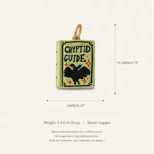 Detailed view of a green copper cryptid guide book pendant with mothman illustration
