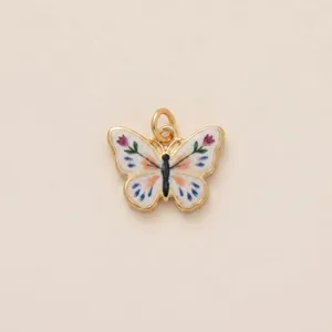 Detail view of an elegant handcrafted enamel butterfly charm for DIY jewelry making.