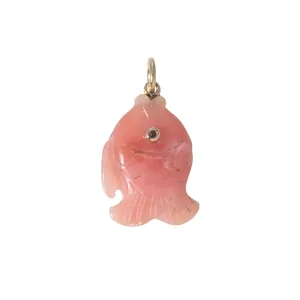 High-quality detailed view of a pink carved fish pendant with gemstone eye and gold bail