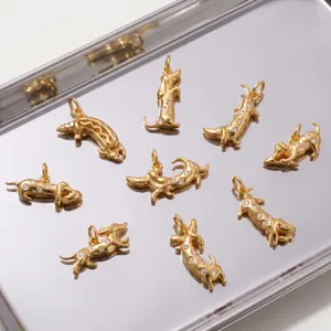 Close-up detail of golden 3D dachshund pendants with sparkling zircon stone accents
