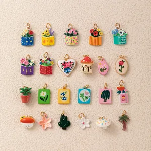 Detailed view of colorful enamel flower and mushroom pendants with 18K gold plating