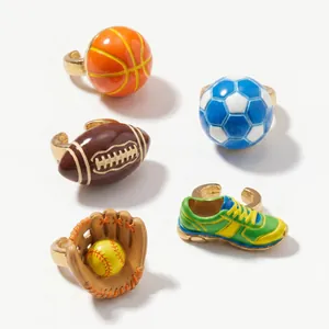 Detailed view of colorful 3D enamel sports ball and sneaker shoe charms on white