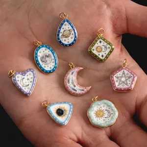 Detailed view of celestial enamel charms featuring sun moon and planet designs
