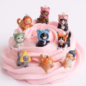 Collection of adorable miniature cat charms with fruit and vegetable hats on pink base
