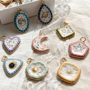 Collection of celestial themed enamel pendants featuring sun, moon and star motifs