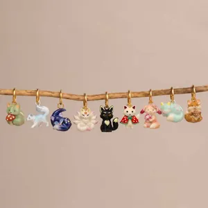 Detailed view of assorted miniature nine-tailed fox and animal charms hanging from a branch