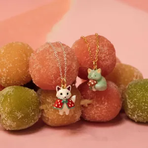 Whimsical fox and cat animal pendants displayed on colorful sugar-coated candy balls.