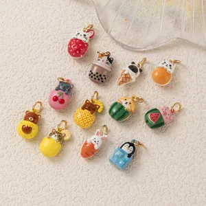 Close-up showing a variety of cute animal and fruit enamel charms for DIY jewelry making.