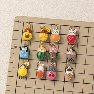 Close-up display of colorful cute animal and fruit themed charms for DIY jewelry making