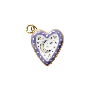 Close-up of heart-shaped copper pendant with moon and stars enamel design for DIY jewelry