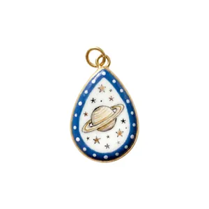 Macro detail of teardrop copper pendant featuring hand-painted Saturn and cosmic stars