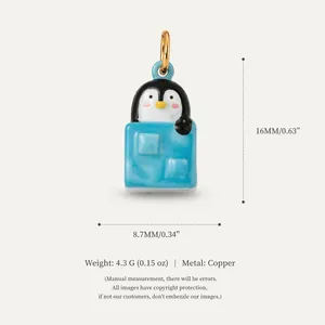 Detailed macro view of cute penguin charm pendant with specific size and weight labels