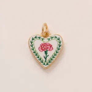 Detailed heart-shaped enamel pendant featuring a pink carnation and green wreath design