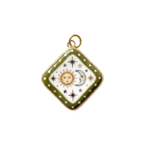 Detail of a square celestial pendant charm featuring a sun and moon illustration for DIY jewelry
