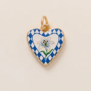 Detail of a heart-shaped pendant with lily flower and blue checkered pattern