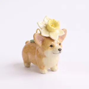 Detailed close-up of a miniature ceramic Corgi pendant with a yellow flower on its head.