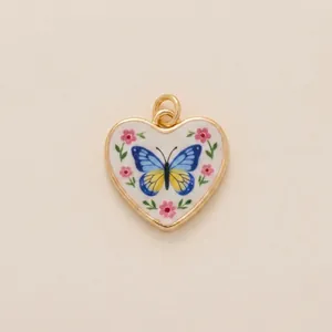 Detailed macro view of a vintage heart pendant with hand-painted blue butterfly motif