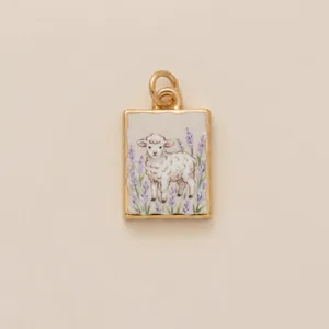 Vintage painted lamb pendant with lavender flowers in a gold frame jewelry detail.