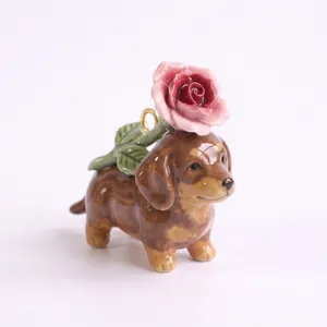 Detailed view of ceramic dachshund puppy charm with pink rose for DIY jewelry