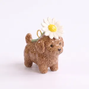 Detailed view of ceramic brown poodle pendant with a white daisy flower on its head