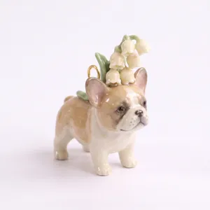Detailed macro shot of a ceramic French Bulldog pendant featuring white lilies