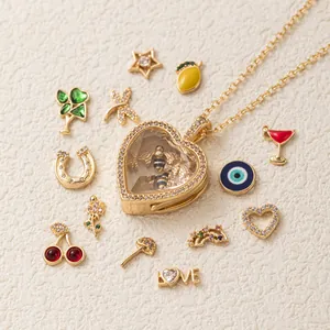 Dettaglio di una collana con medaglione a cuore dorato e vari ciondoli fai-da-te colorati