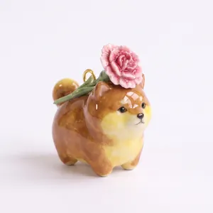 Detailed macro view of a ceramic Shiba Inu dog charm with a pink flower decoration