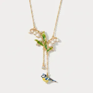 Collana vintage in smalto mughetto con ciondolo uccellino blu e dettagli in cristallo