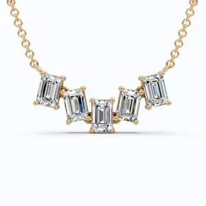 Detail of gold-plated stainless steel necklace with five emerald-cut cubic zirconia stones.