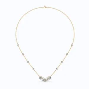 Detailed view of gold necklace featuring baguette-cut and round zirconia stones