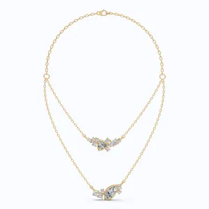 Detailed view of gold double-layered necklace with marquise and triangle zircons.