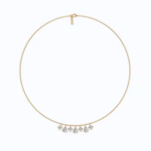 Detailed view of a gold dainty chain necklace featuring pear and round zirconia fringe