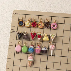 Macro view of assorted miniature dessert cake and donut charms for DIY jewelry making