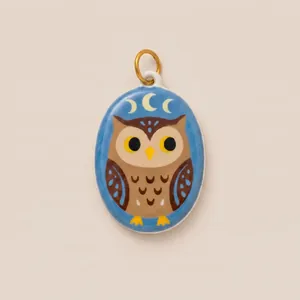 Detailed macro view of the handcrafted enamel owl pendant with crescent moon pattern.