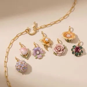 Vintage enamel flower pendants with pearls in various floral designs for elegant jewelry