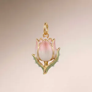 Close-up of a vintage floral enamel tulip pendant with white pearls and gold finish