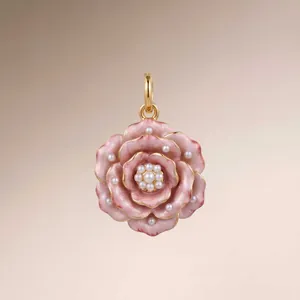 Detailed view of handcrafted pink enamel rose pendant featuring elegant pearl accents