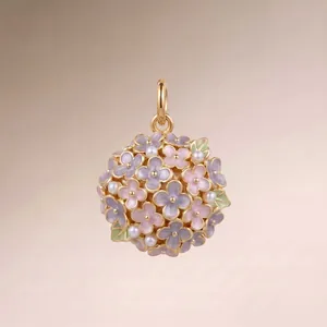 Detailed view of a gold floral ball pendant featuring pastel enamel and white pearls.