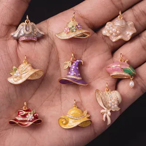 Detailed view of nine vintage enamel hat charms with zirconia and pearls for DIY jewelry