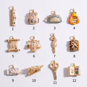 Collection of 12 artistic stationery charms with enamel and pearls for DIY jewelry.