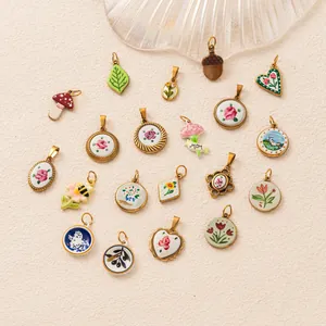 Detailed view of assorted vintage floral and botanical 18K gold plated steel pendants.
