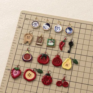 Collection of stainless steel fruit and vegetable button pendants for DIY jewelry design.